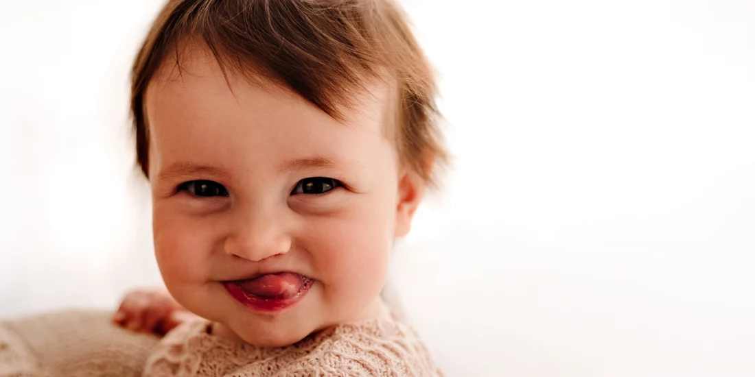 Foto ritrattistica a colori di una bambina che fa la linguaccia. Fotografia ritratto a colori di una bambina che fa la linguaccia Trieste